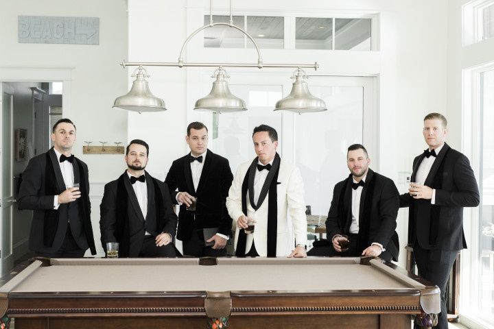 groom and groomsmen having a drink before wedding