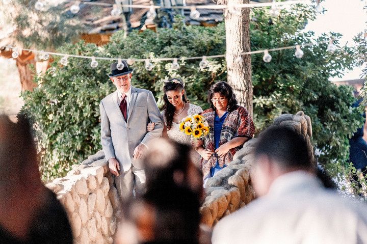 bride walking down the aisle with parents