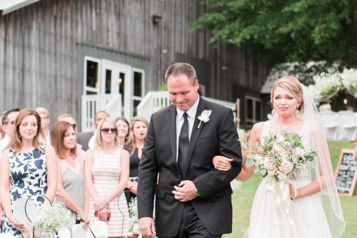 bride walking down aisle and crying