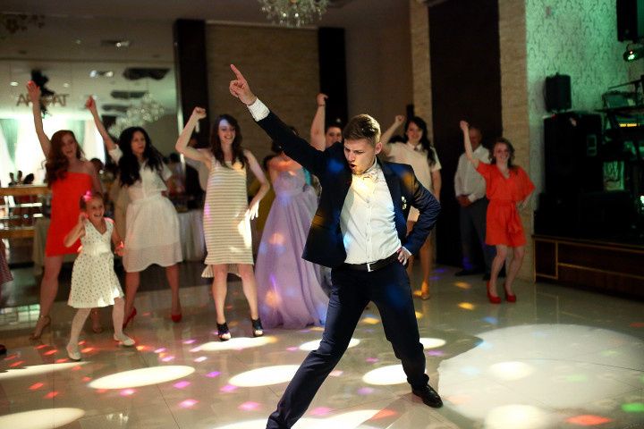 man doing silly dance at wedding