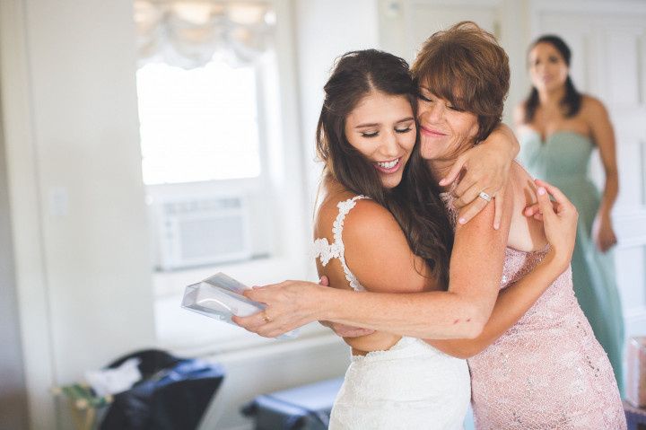 mother and daughter hugging on wedding day