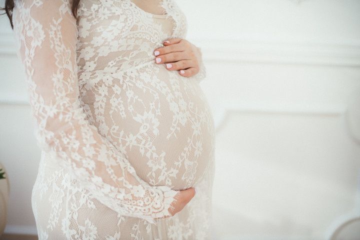 pregnant bride in lace wedding dress