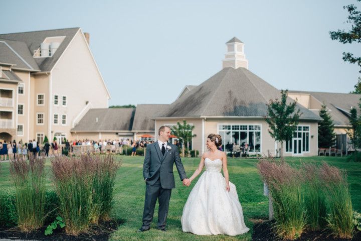 couple holding hands in front of wedding venue