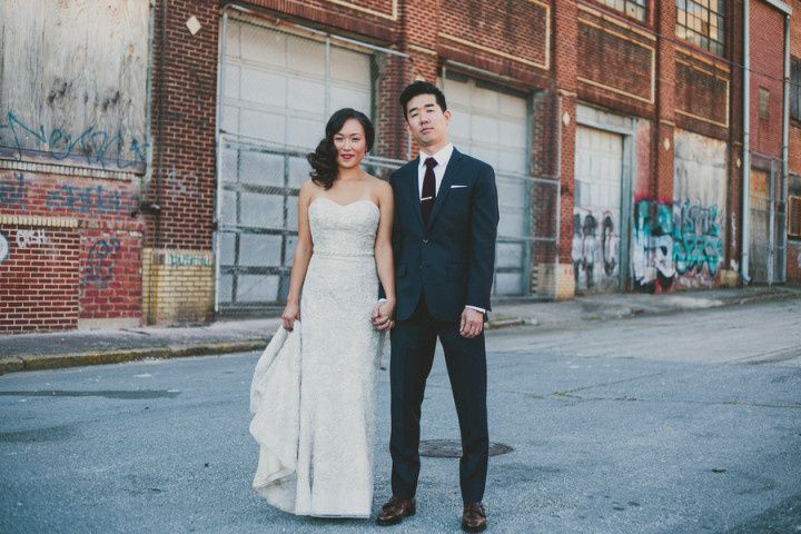 couple standing in front of factory space