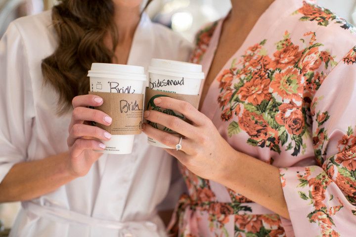 bride and bridesmaid holding starbucks cups