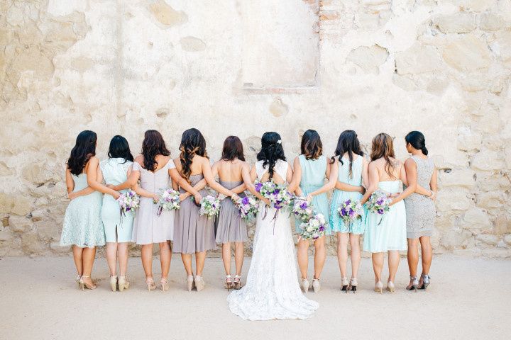 group of bridesmaids with arms around each other
