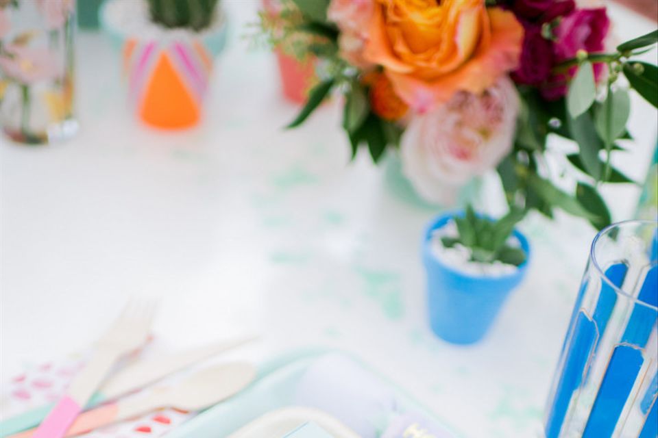 wedding place setting with whimsical pastel color palette and geometric favor box