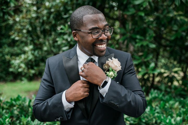 groom straightening his tie