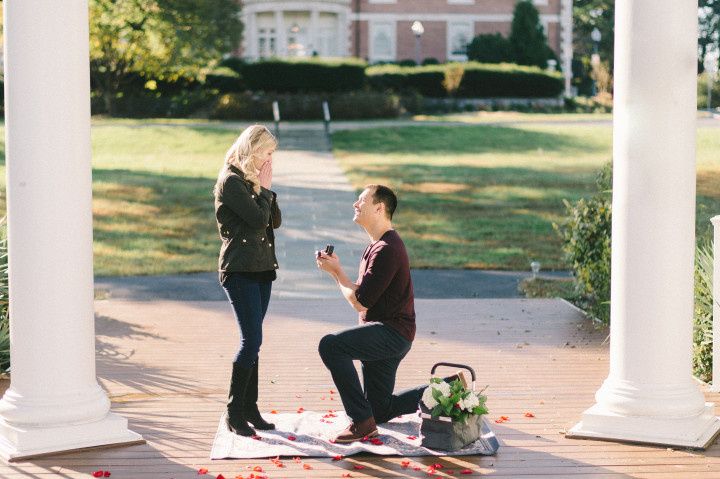 a man proposing to a woman outdoors down on one knee