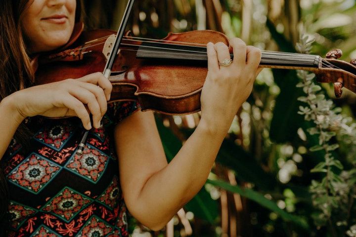 woman playing violin outdoors