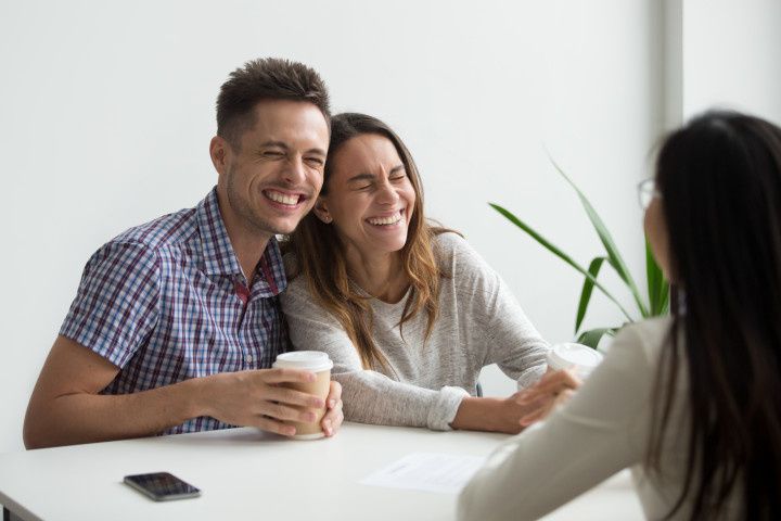couple in a meeting laughing