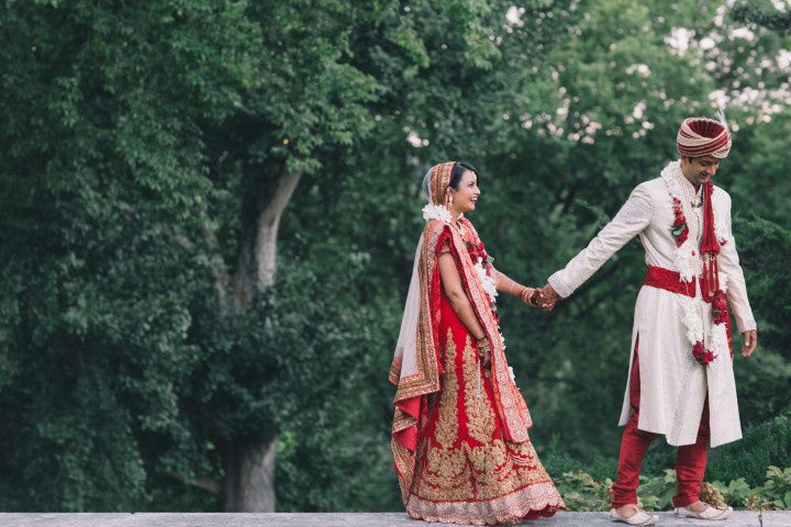 indian wedding couple walking hand in hand