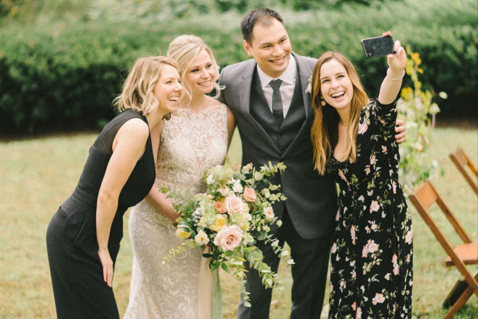 bride and guests taking a selfie