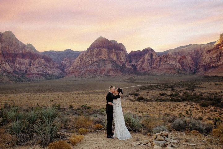 bride and groom posing in las vegas desert canyon