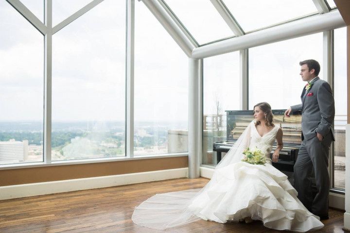 bride and groom pose for wedding portrait in penthouse at City Club of Birmingham, Alabama