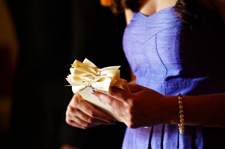 woman holding wedding programs