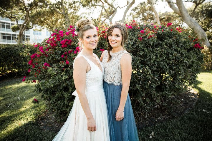 bride in bhldn wedding dress and maid of honor in crop top bridesmaid dress bhldn