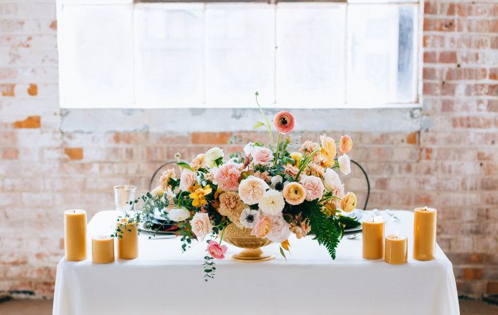 romantic wedding tablescape with blush garden rose centerpiece and candles 