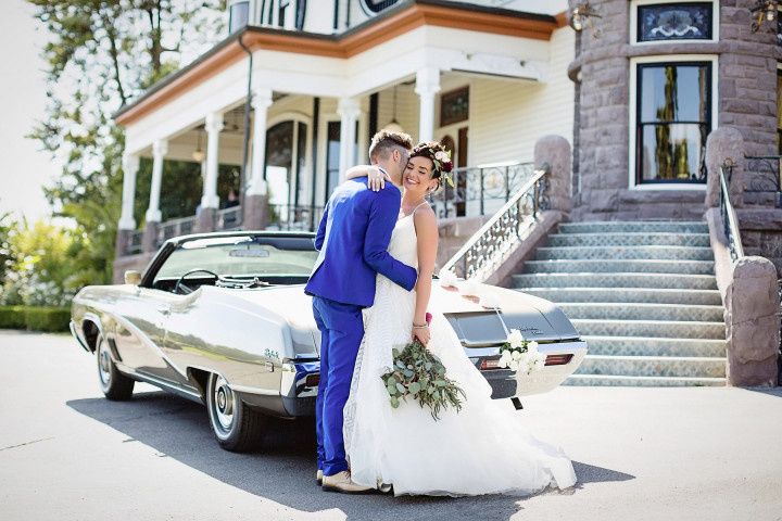 couple posing by vintage car 