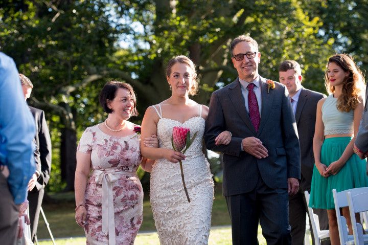 bride with parents walking down aisle 