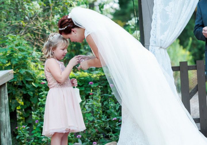 bride giving child ring during ceremony 