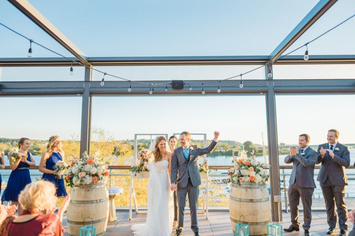 bride and groom hold hands and face their guests after their wedding at district winery 