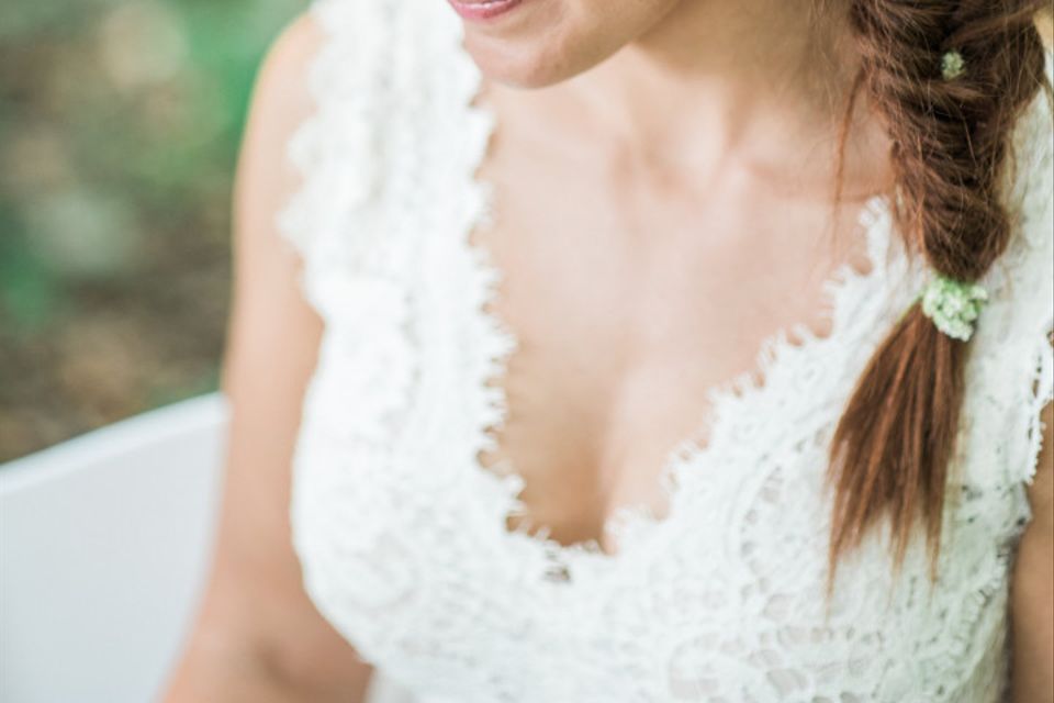 bride with fishtail braid sitting outside for portrait