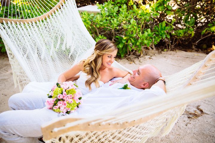 wedding couple relaxing on a hammock at a beach wedding