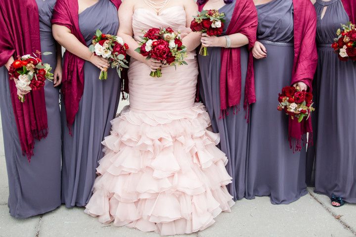 winter bride with blush wedding dress standing next to bridesmaids