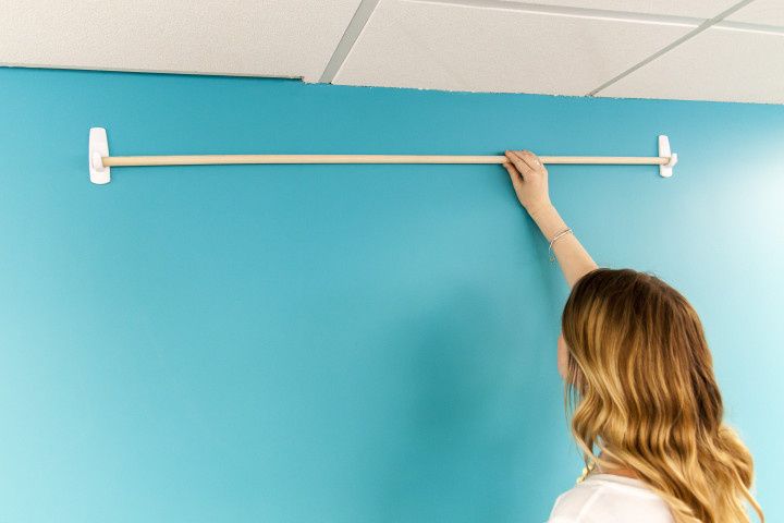 DIY Hanging photo backdrop reusable hooks blue wall 