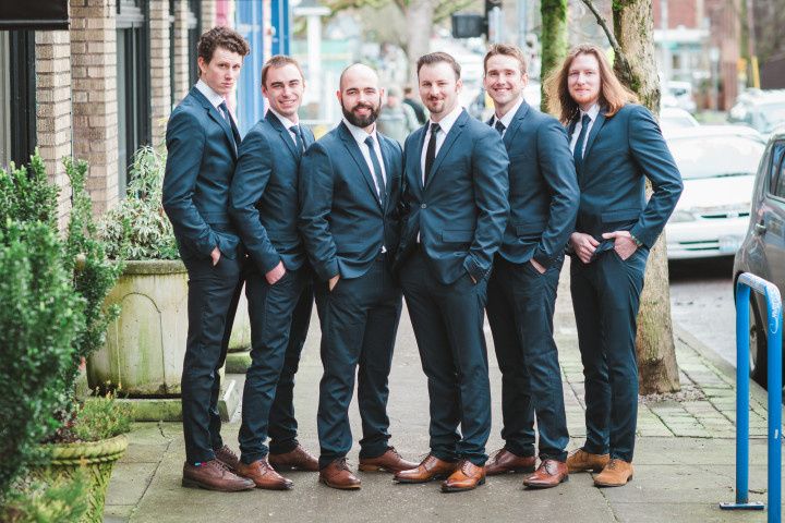groom and groomsmen outdoor portrait matching navy suits brown shoes