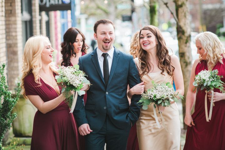 groom walking with bridesmaids 