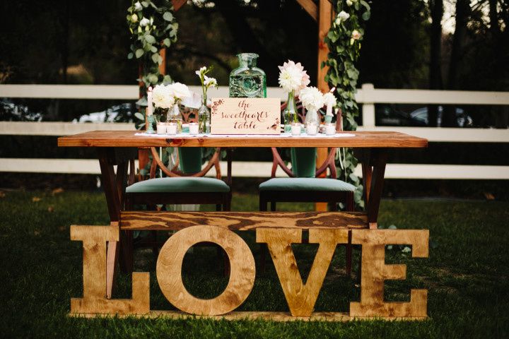 shabby chic rustic outdoor sweetheart table marquis letters floral arch