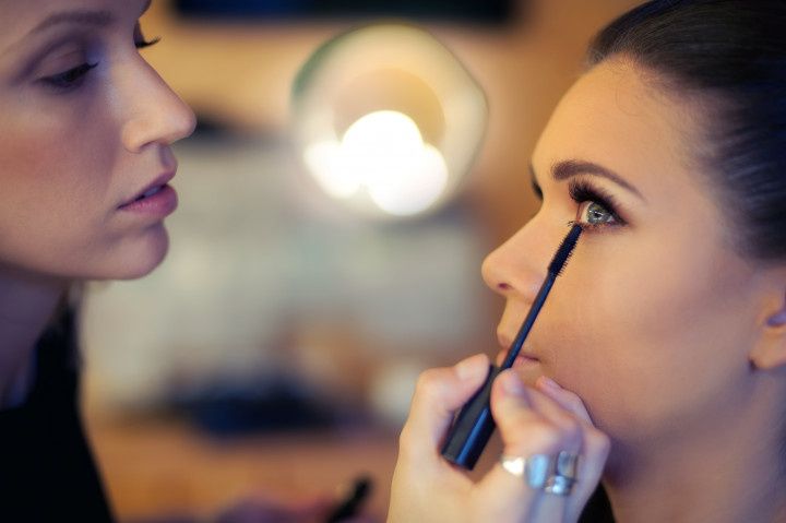woman having mascara applied