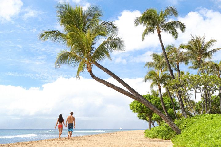 couple walking on maui beach stock