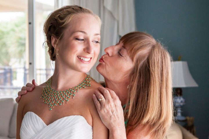 mother of the bride kissing bride 