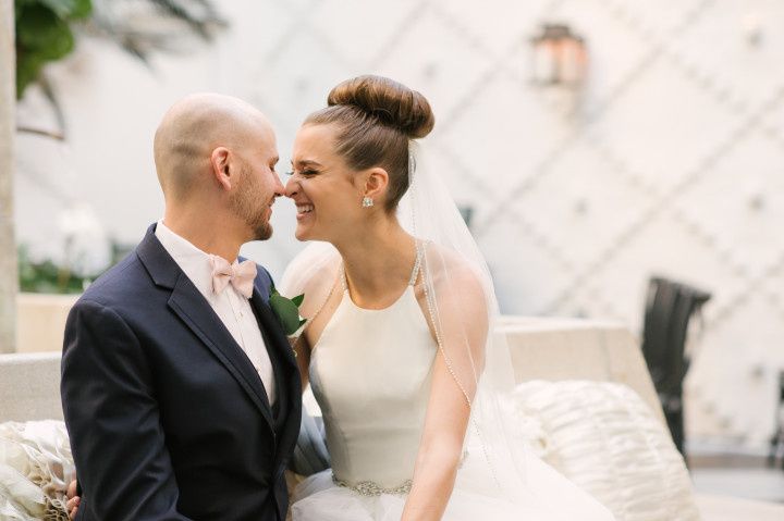 nuzzling wedding couple