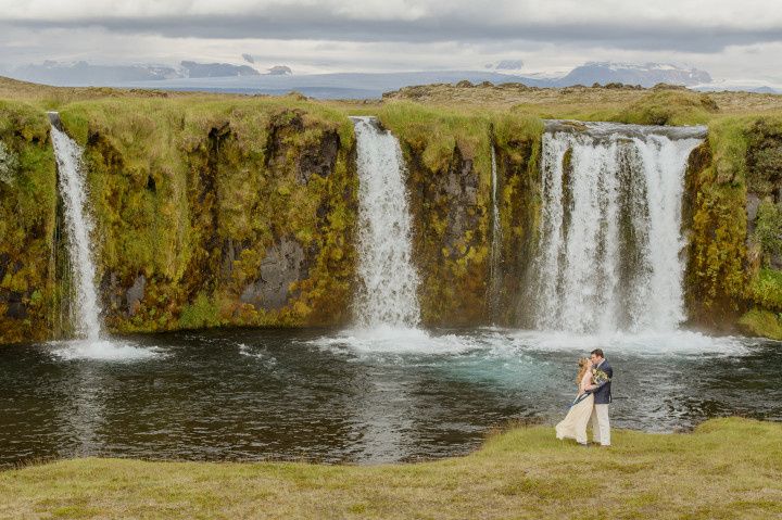 couple posing with scenic waterfall backdrop