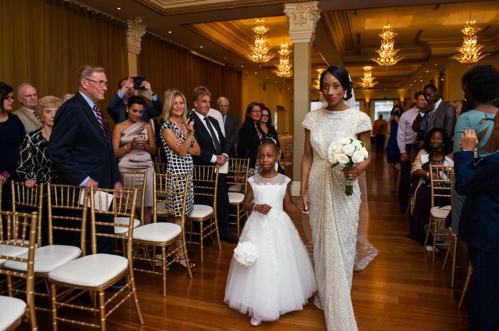 bride and daughter walking down aisle together 