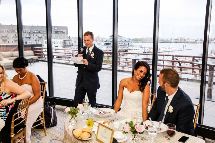 couple at reception table during best man speech