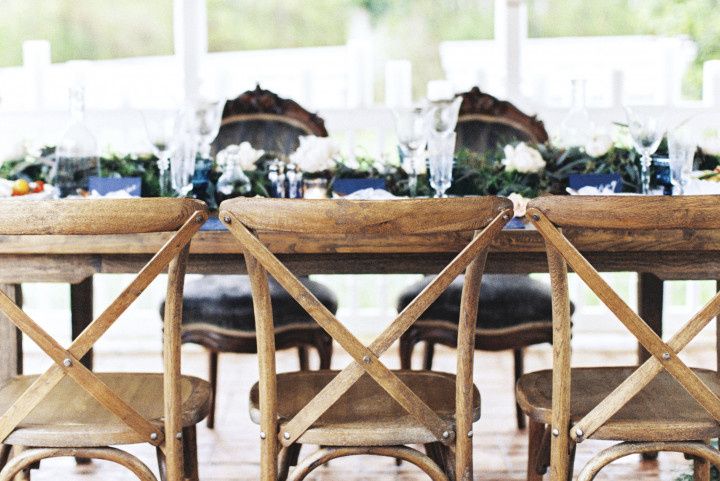 Rehearsal dinner table with flowers and cross back chairs