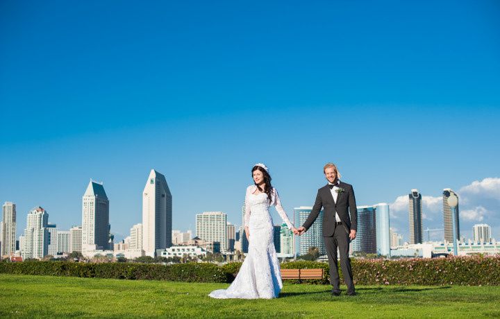 wedding couple holding hands and overlooking san diego