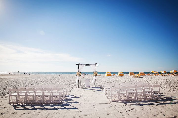 Beach ceremony in Clearwater Beach, Florida with oceanfront view and yellow umbrellas