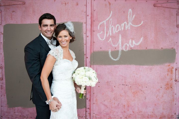 couple standing next to thank you sign 