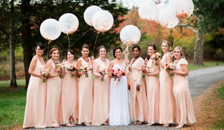 bridal party carrying balloons