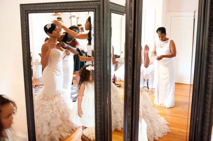 bride in pink gown looking in mirror 