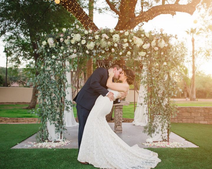 couple kissing in front of ceremony altar