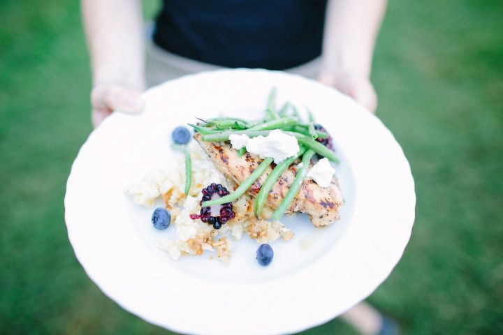 guest holding chicken entree