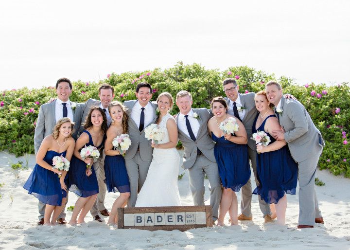 beach wedding party with last name sign