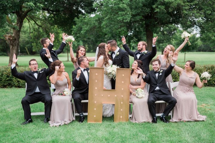 wedding party cheering with marquee letter